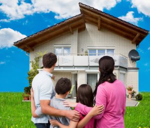 A family standing in front of their home.