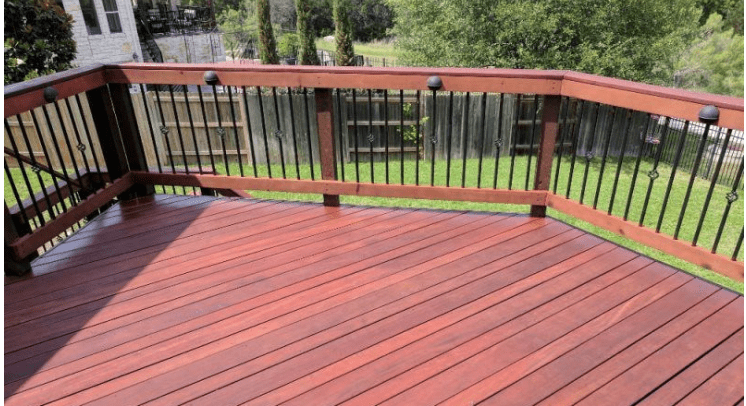 A deck with wood and metal railing.
