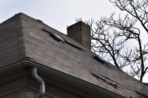 A roof with some missing pieces and a gutter